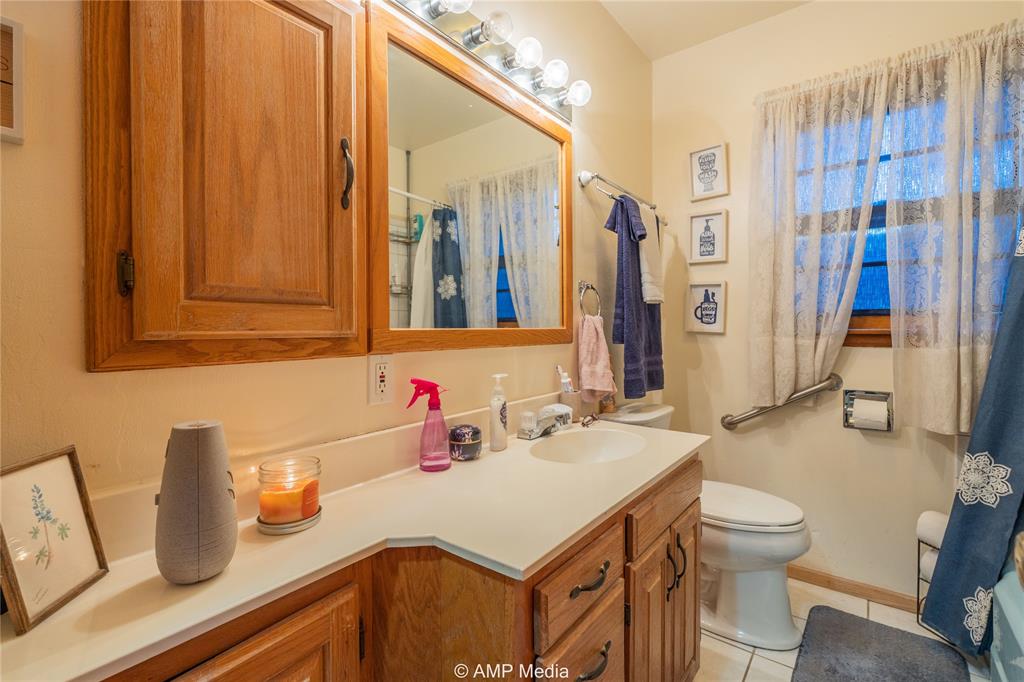 704 East Burnside Street Rotan, TX 79546 - Photo 17 of 31 a bathroom with a sink and a mirror