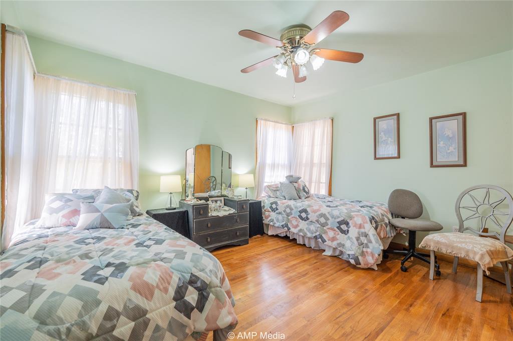 704 East Burnside Street Rotan, TX 79546 - Photo 20 of 31 a bedroom with furniture and a large mirror