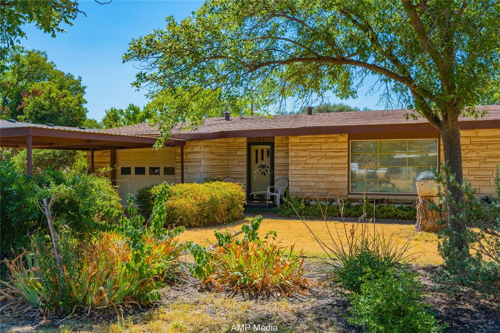 704 East Burnside Street Rotan, TX 79546 - Photo 2 of 31 a view of a house with a yard