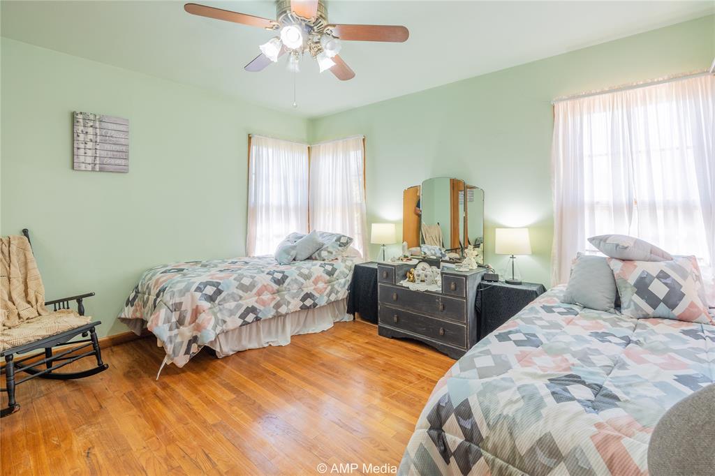 704 East Burnside Street Rotan, TX 79546 - Photo 21 of 31 a bedroom with a bed and a chandelier