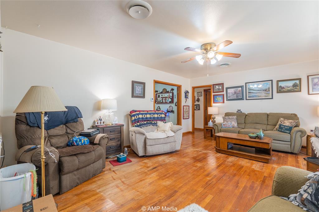704 East Burnside Street Rotan, TX 79546 - Photo 6 of 31 a living room with furniture and a chandelier