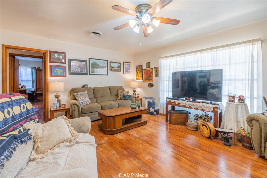 704 East Burnside Street Rotan, TX 79546 - Photo 7 of 31 a living room with furniture and a flat screen tv
