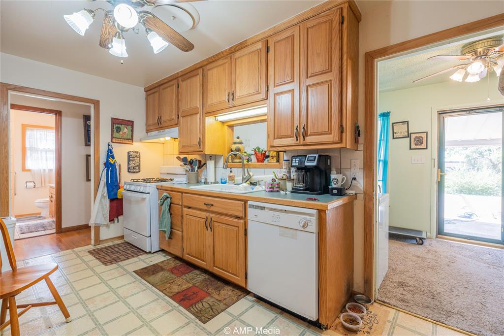 704 East Burnside Street Rotan, TX 79546 - Photo 10 of 31 a kitchen with a sink cabinets and window