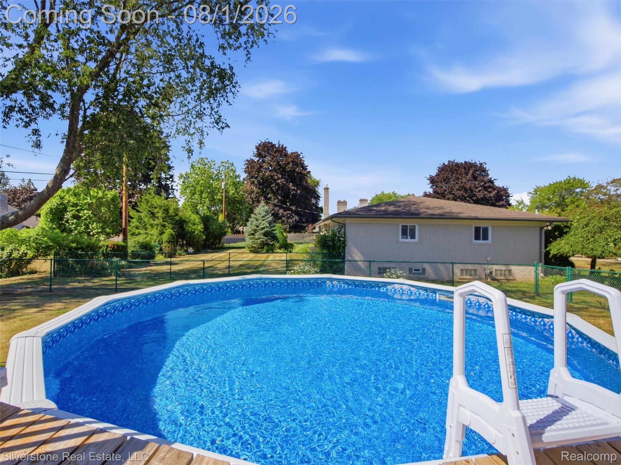2135 Wayward Drive Rochester, MI 48309 - Photo 47 of 55 Backyard featuring an above-ground octagonal pool with a liner, surrounded by a wood-finish deck