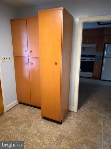an empty room with closet and wooden door
