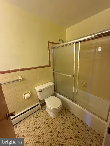 a bathroom with a sink toilet and mirror