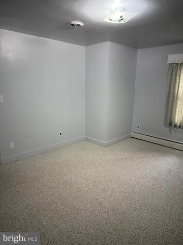 a view of an empty room with a fireplace