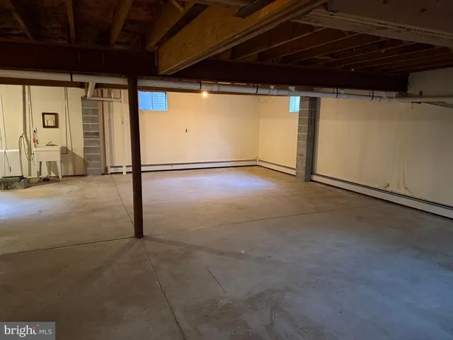 a view of an empty room with furniture and a garage