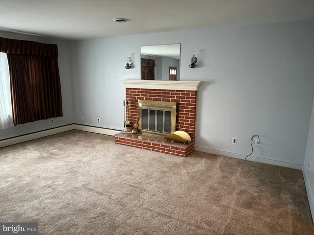 an empty room with fireplace