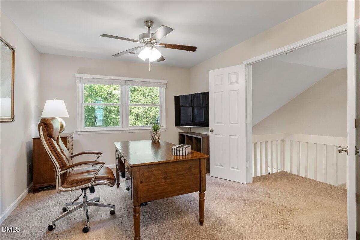 8321 Hempshire Place, Unit 103 Raleigh, NC 27613 - Photo 16 of 25 a living room with furniture and a flat screen tv