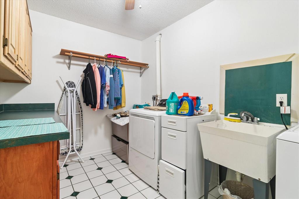 3007 McReynolds Road Sanger, TX 76266 - Photo 16 of 39 Dedicated laundry room featuring white and dark green checkered tile flooring