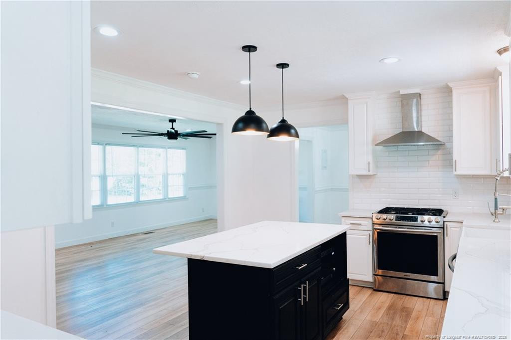 309 Cornith Road Pembroke, NC 28372 - Photo 13 of 40 a kitchen with stainless steel appliances a stove a sink dishwasher a refrigerator and a wooden floor