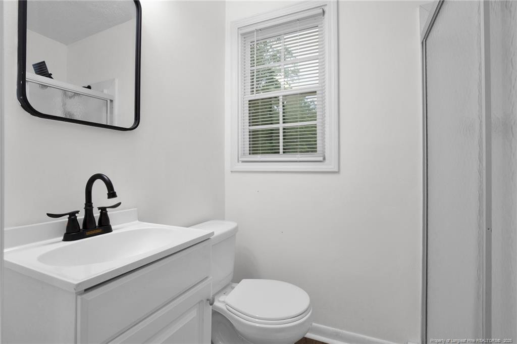 309 Cornith Road Pembroke, NC 28372 - Photo 30 of 40 a bathroom with a toilet a sink and mirror