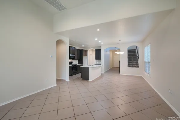 a view of a kitchen with furniture and an empty room