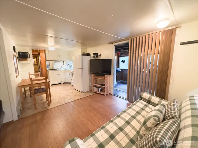 a view of a livingroom with furniture and a flat screen tv