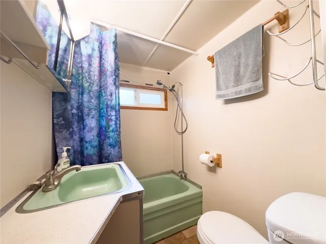 a bathroom with a sink a toilet and tub