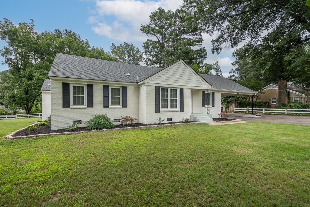 670 Peterson Lake Road Collierville, TN 38017 - Photo 34 of 37 White brick exterior with dark shutters, gabled roofline, and attached carport