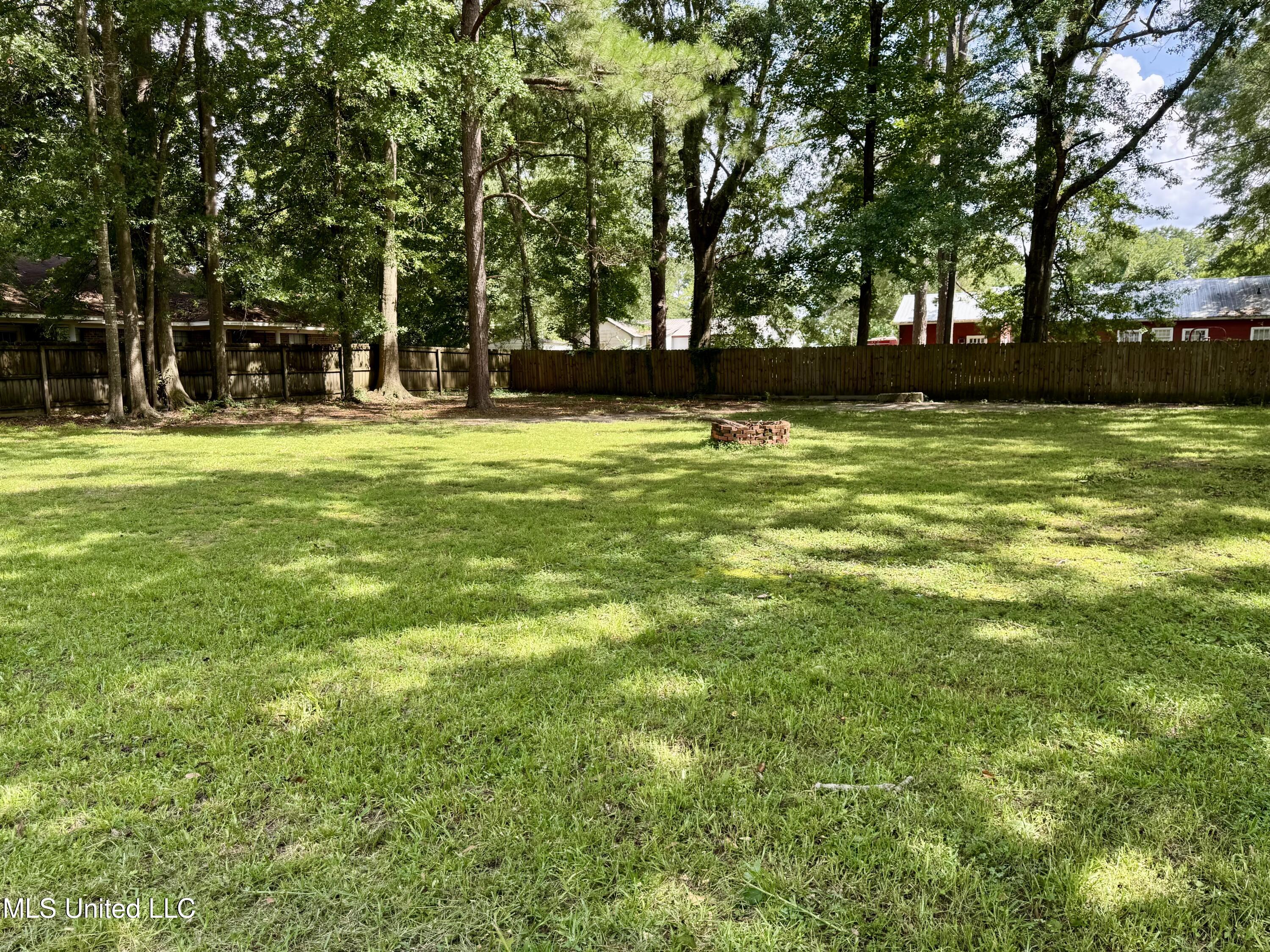 214 East Church Street Quitman, MS 39355 - Photo 19 of 22 Large backyard with fire pit