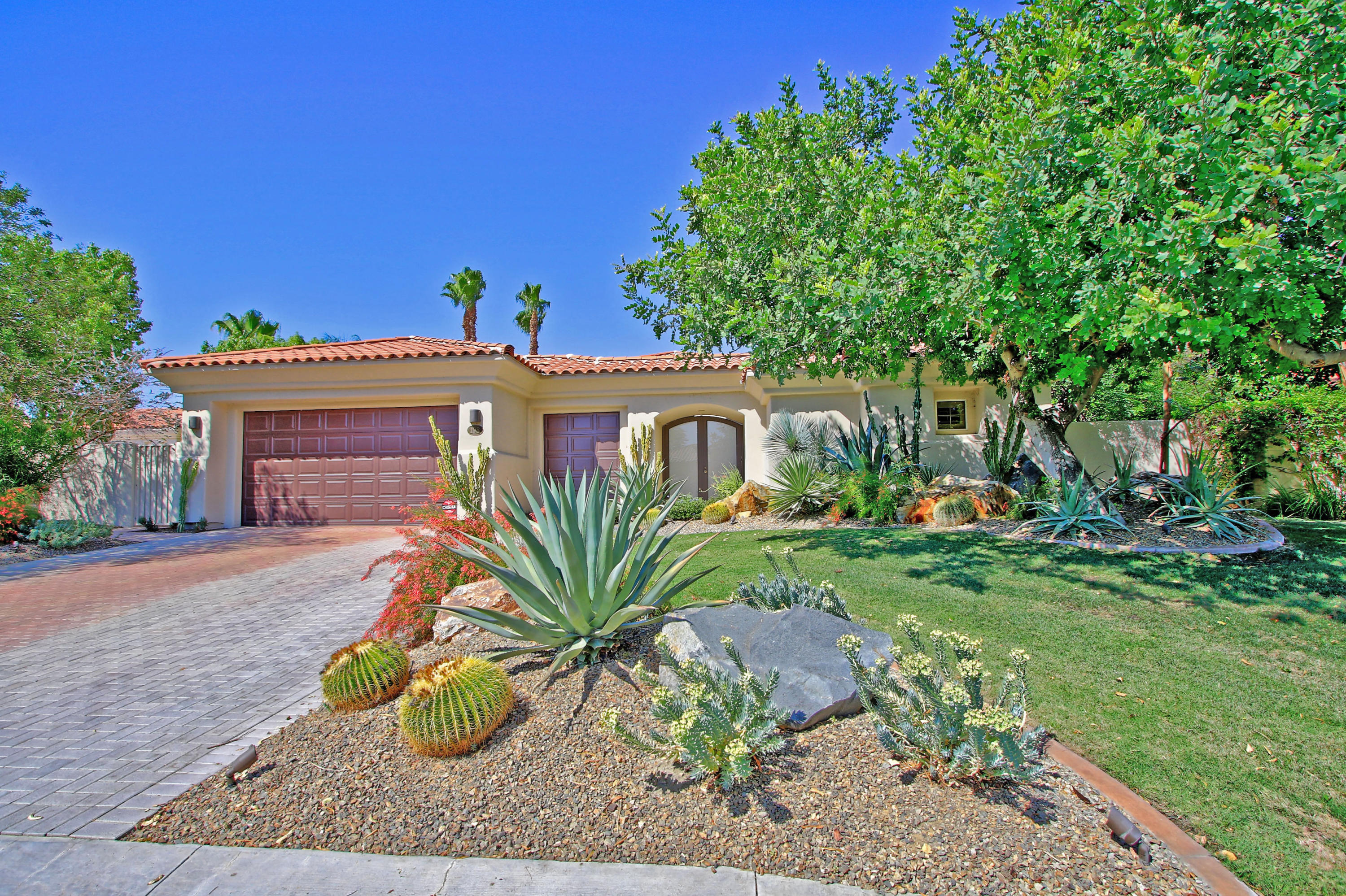 198 Loch Lomond Road Rancho Mirage, CA 92270 - Photo 1 of 5 a front view of a house with garden