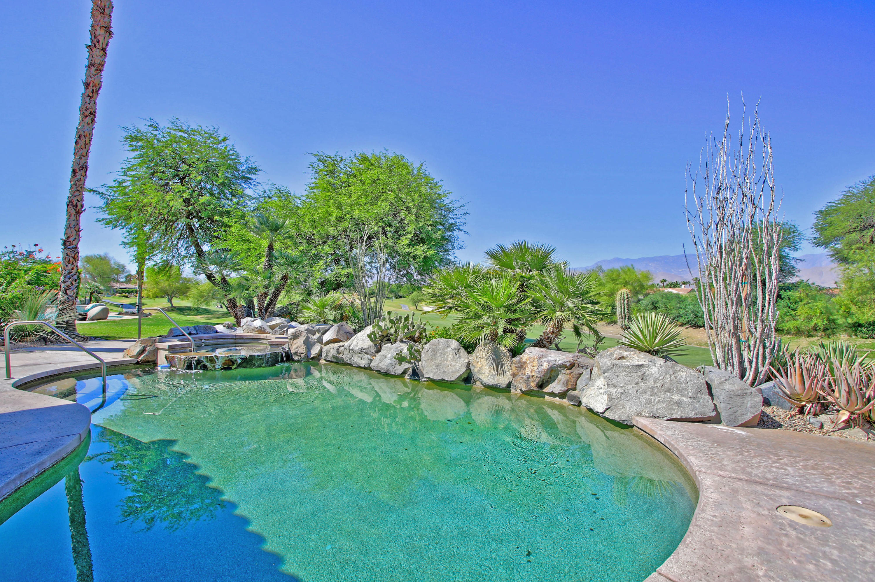 198 Loch Lomond Road Rancho Mirage, CA 92270 - Photo 4 of 5 a view of a chair and table in the garden