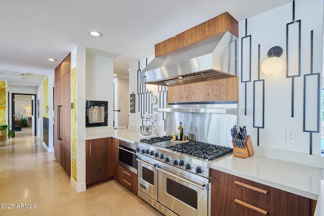 a living room with patio furniture and a fireplace