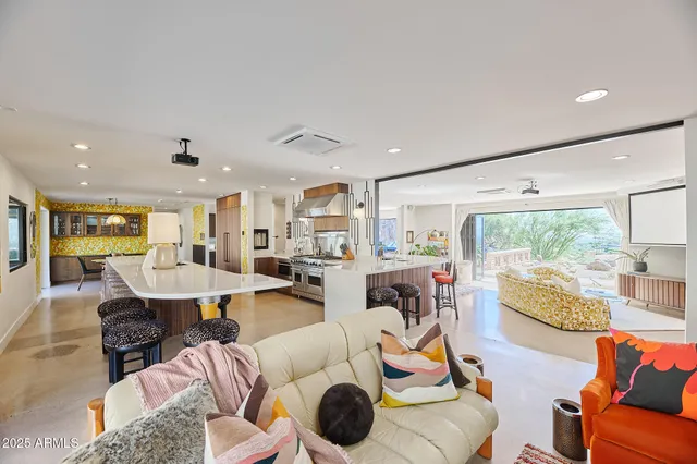 a bed room with a bed couch and a large window