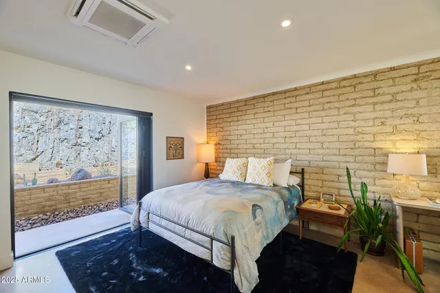 a bedroom with a bed and a night stand