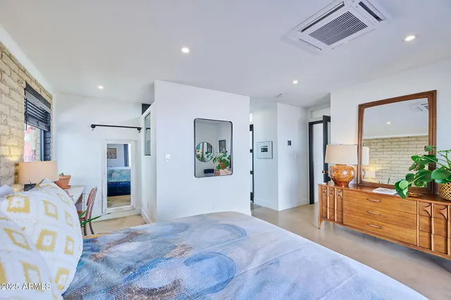 a room with a large mirror and furniture