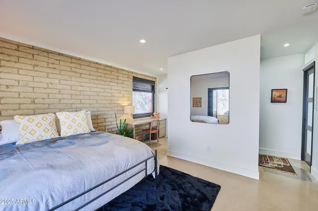 a bedroom with a bed and a window with the outer view