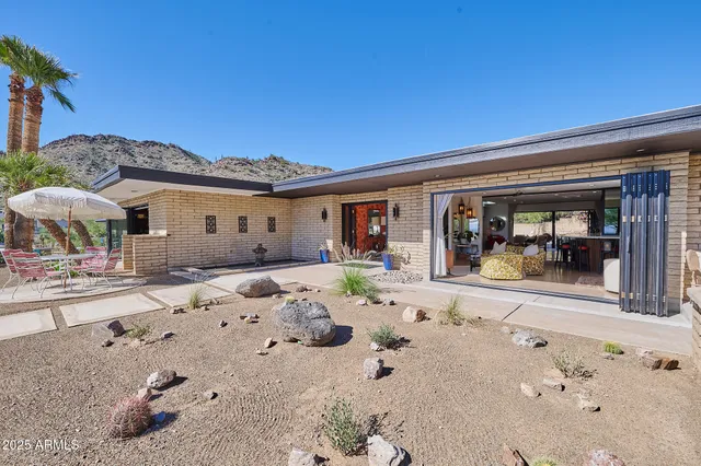 a view of a dry yard with a table and chair
