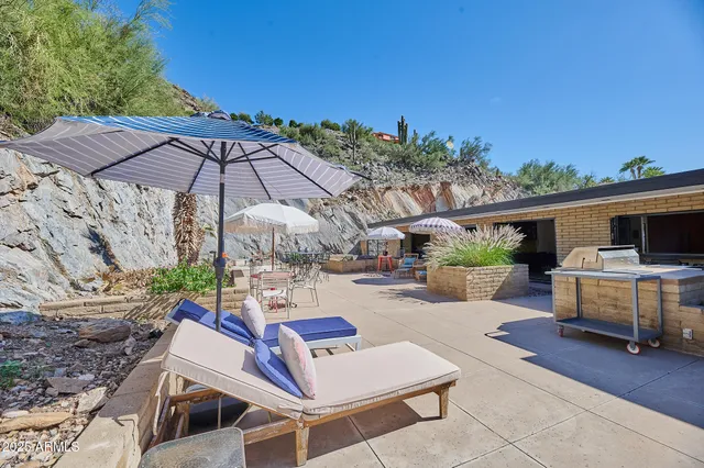 a view of a house with backyard porch and sitting area