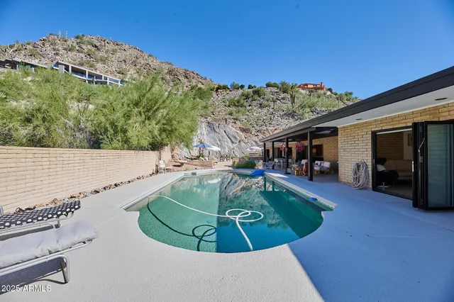 a view of a patio with swimming pool table and chairs