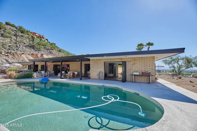 swimming pool view with a seating space