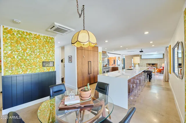 a view of a dining room with furniture a chandelier and wooden floor