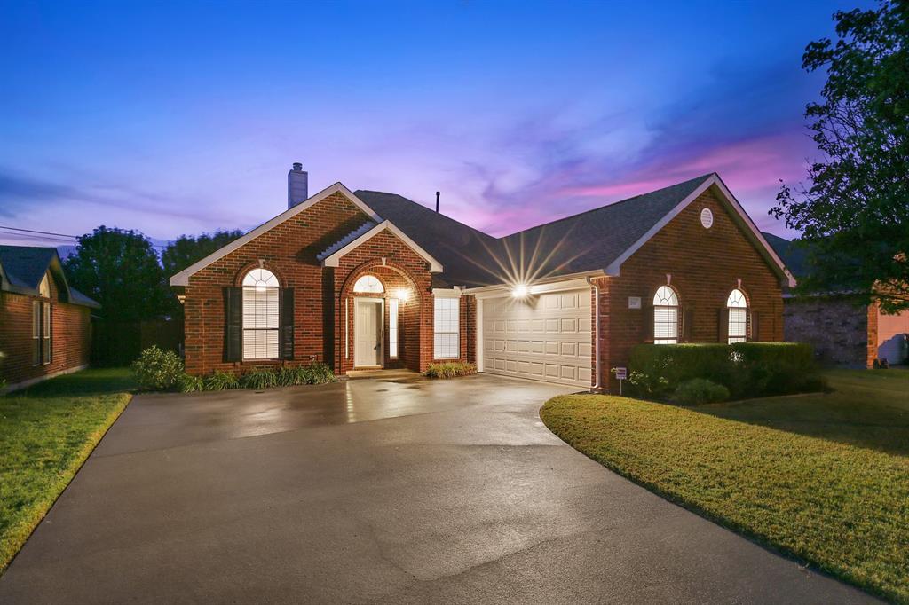 a front view of a house with yard and green space