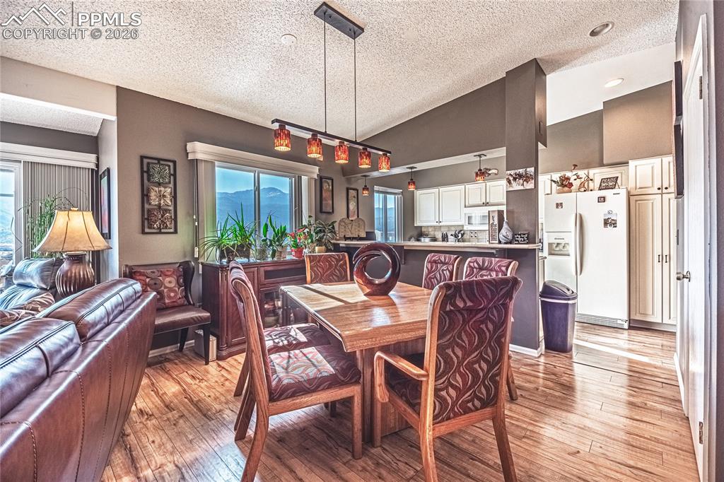 1126 Fontmore Road, Unit C Colorado Springs, CO 80904 - Photo 15 of 35 a dining room with furniture a chandelier and wooden floor