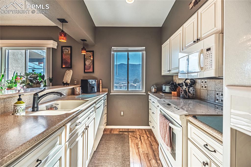 1126 Fontmore Road, Unit C Colorado Springs, CO 80904 - Photo 18 of 35 a kitchen with granite countertop a sink stove and cabinets