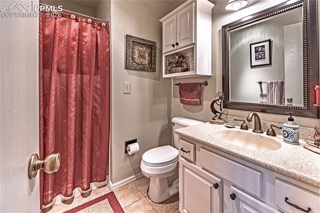 1126 Fontmore Road, Unit C Colorado Springs, CO 80904 - Photo 24 of 35 a bathroom with a granite countertop sink mirror vanity and toilet