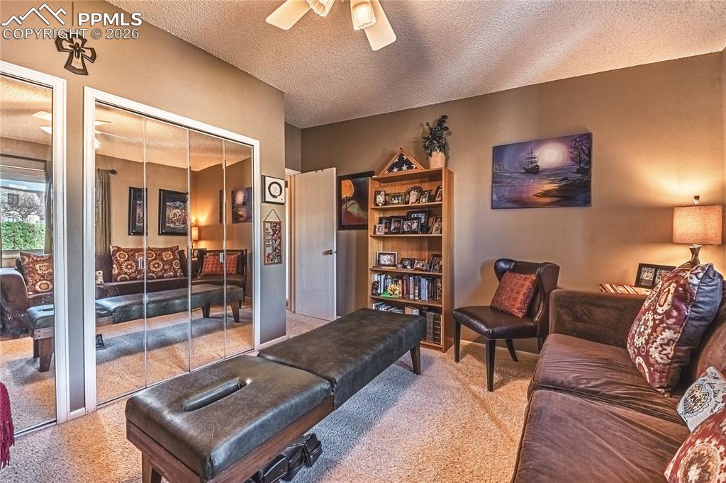 1126 Fontmore Road, Unit C Colorado Springs, CO 80904 - Photo 26 of 35 a living room with furniture and a book shelf