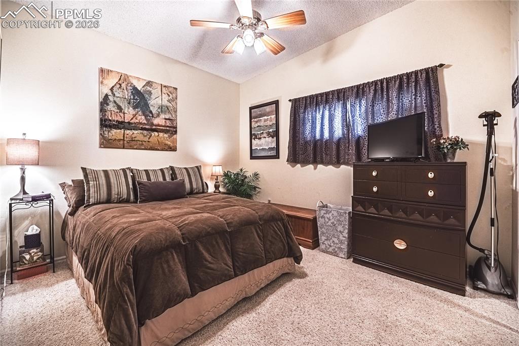 1126 Fontmore Road, Unit C Colorado Springs, CO 80904 - Photo 27 of 35 a bedroom with a bed and a dresser