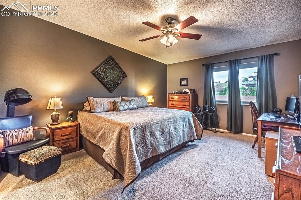 1126 Fontmore Road, Unit C Colorado Springs, CO 80904 - Photo 29 of 35 a bedroom with a bed and lamp chandelier