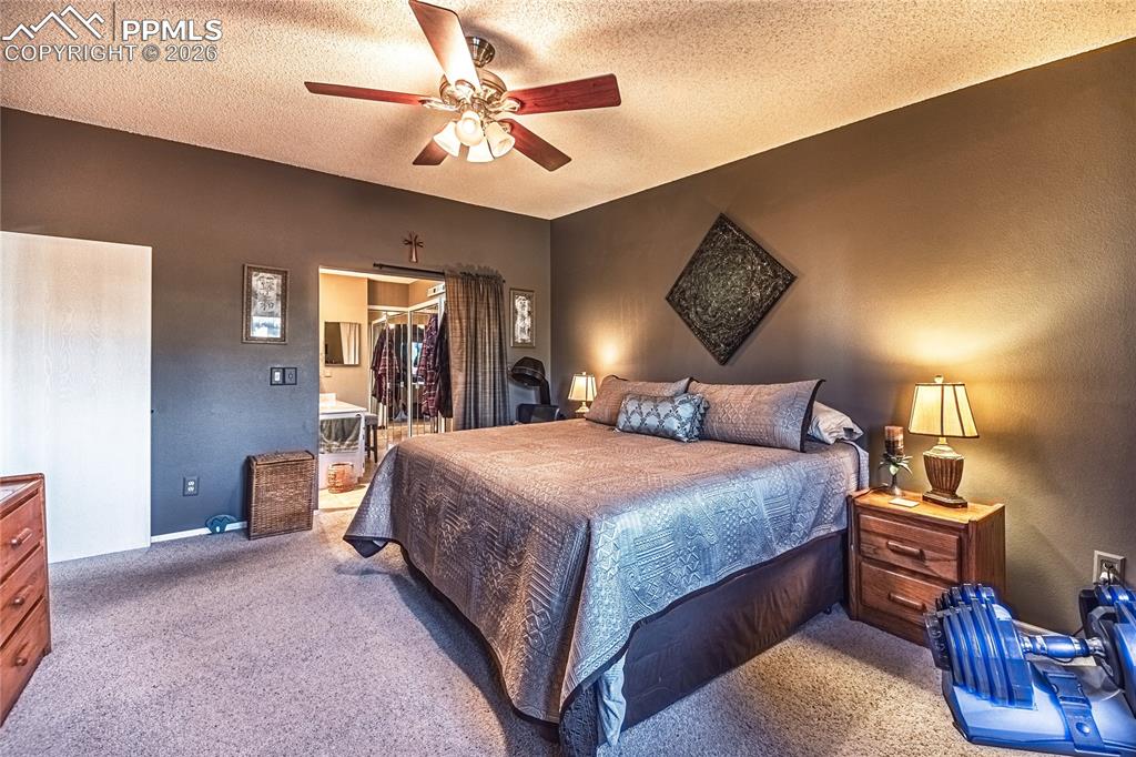 1126 Fontmore Road, Unit C Colorado Springs, CO 80904 - Photo 30 of 35 a bedroom with a bed and a chandelier