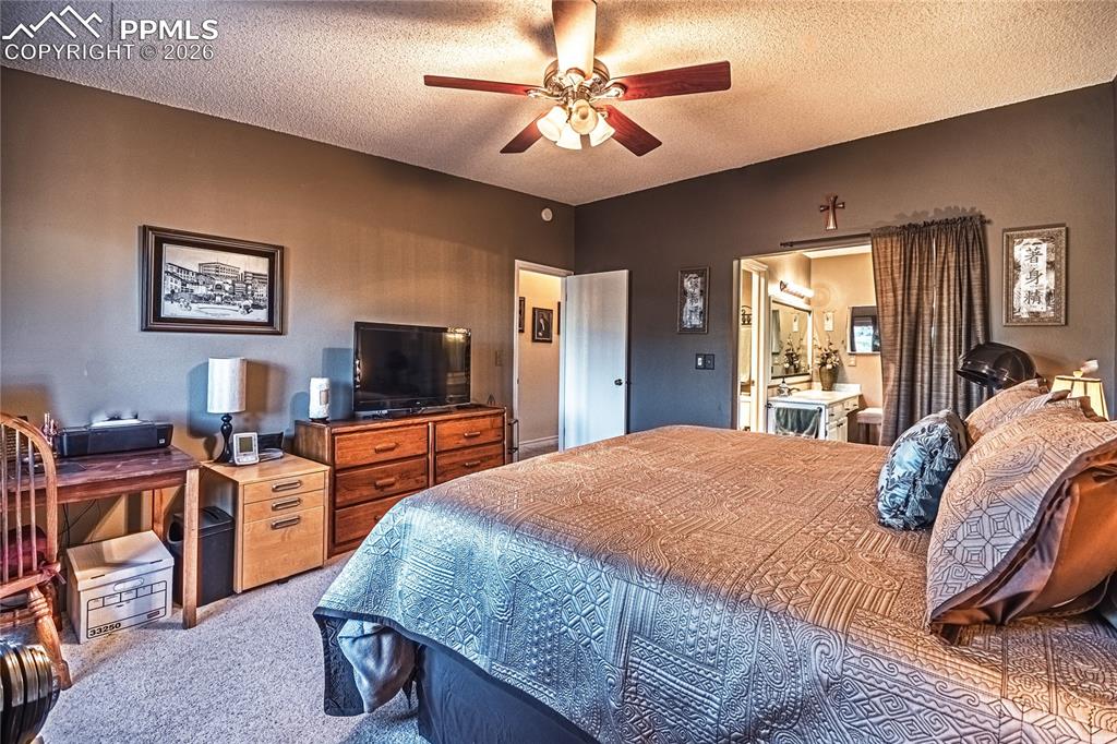 1126 Fontmore Road, Unit C Colorado Springs, CO 80904 - Photo 31 of 35 a bedroom with a bed and a flat screen tv