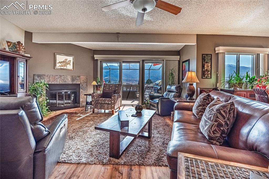 1126 Fontmore Road, Unit C Colorado Springs, CO 80904 - Photo 7 of 35 a living room with fireplace furniture and a large window