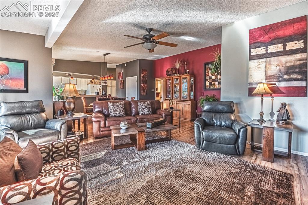 1126 Fontmore Road, Unit C Colorado Springs, CO 80904 - Photo 9 of 35 a living room with furniture a chandelier and a large window