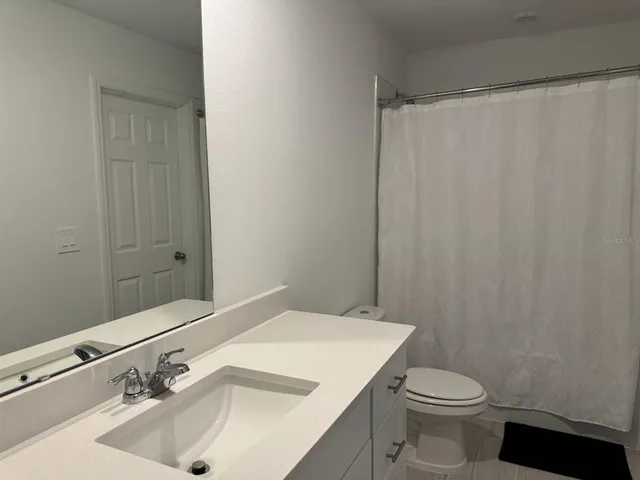 a bathroom with a sink and toilet