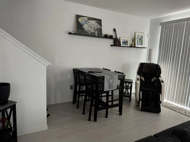 a dining room with furniture and wooden floor