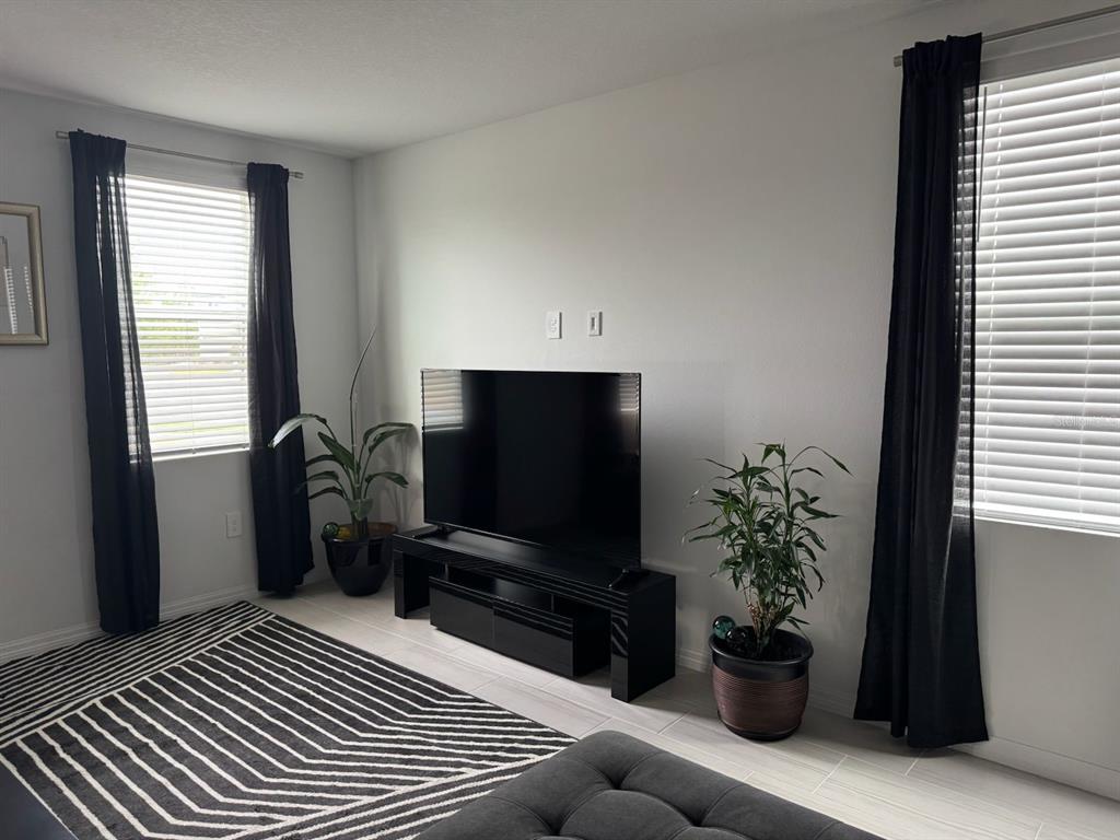 4469 Eagle Trl Bend St. Cloud, FL 34772 - Photo 6 of 13 a living room with furniture and a potted plant