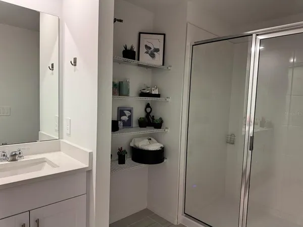 a bathroom with a shower and a sink