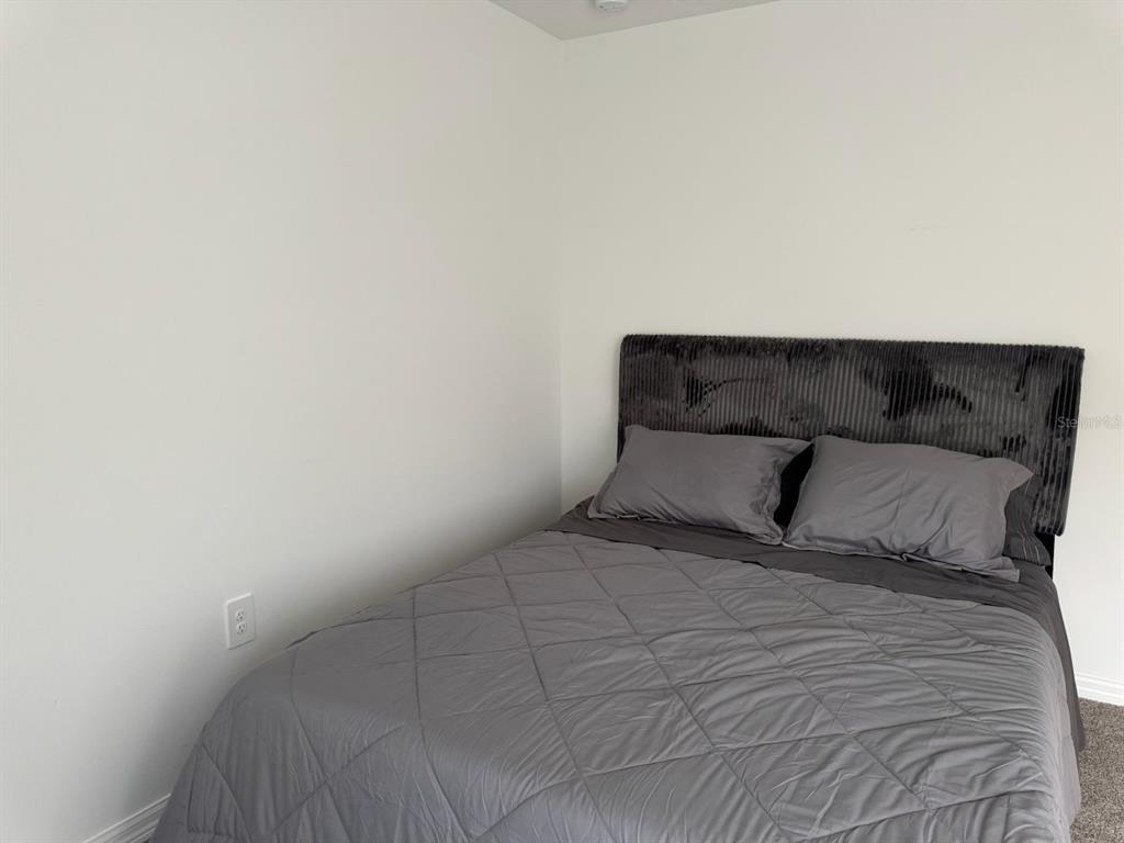 4469 Eagle Trl Bend St. Cloud, FL 34772 - Photo 9 of 13 a bed sitting in a bedroom with a window